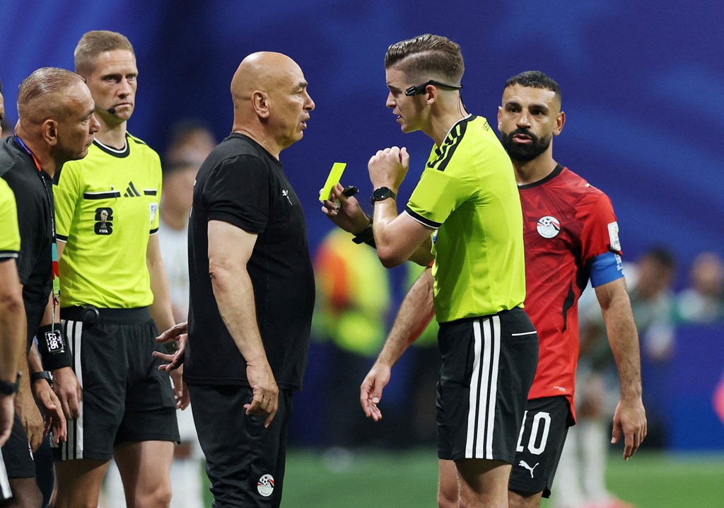 Hossam Hassan is shown a yellow card by referee Francois Letexier
