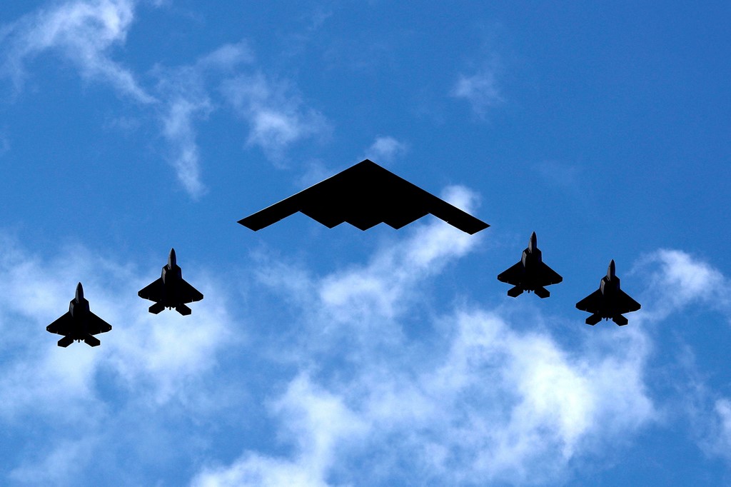 A US B-2 bomber flanked by F-35 jets