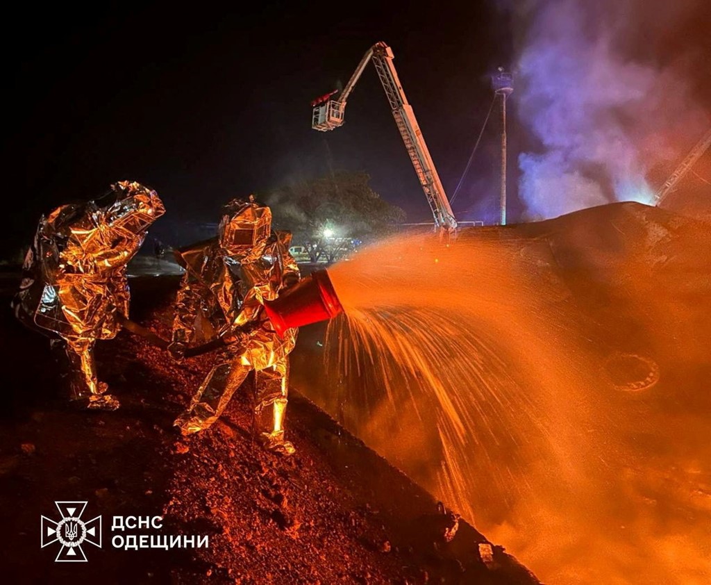 Firefighters work at a facility hit by a Russian strike in Odesa