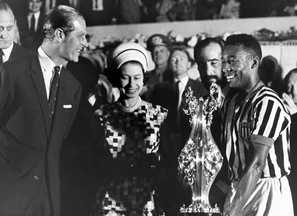 Pele is presented with a trophy by the Queen and Prince Philip in Rio de Janeiro during a state visit in 1968