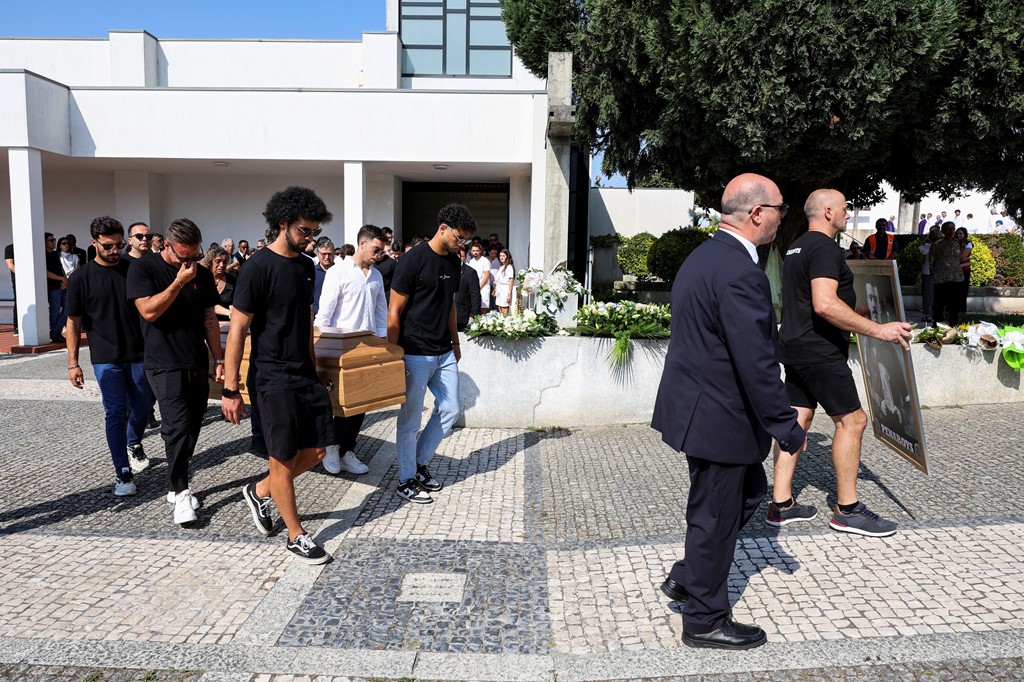 Pallbearers carrying one of the coffins