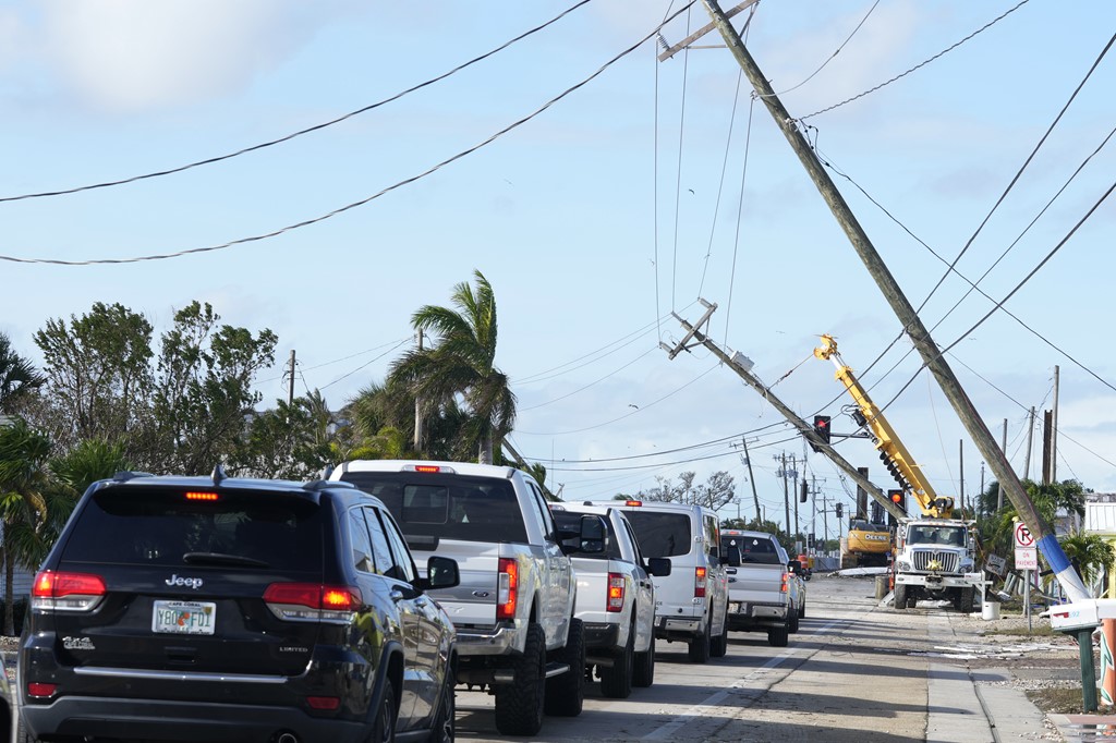 Cars move slowly after Hurricane Milton damaged power lines in Matlacha