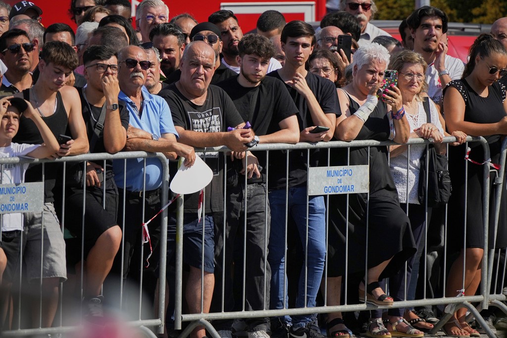 Crowd watches procession