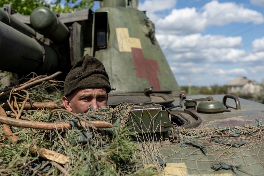 A Ukrainian soldier looks out from a tank, amid Russia's invasion of Ukraine, in the frontline city of Lyman