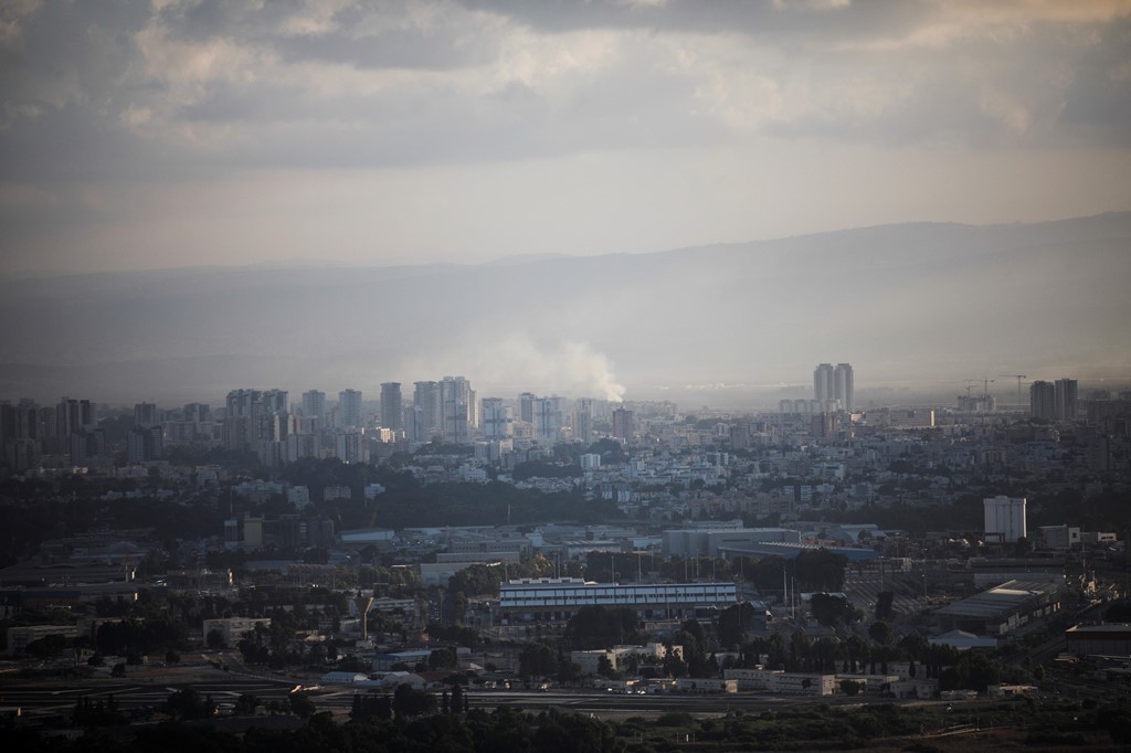 Smoke rises above Haifa after rockets were fired from Lebanon into Israel. Pic: Reuters