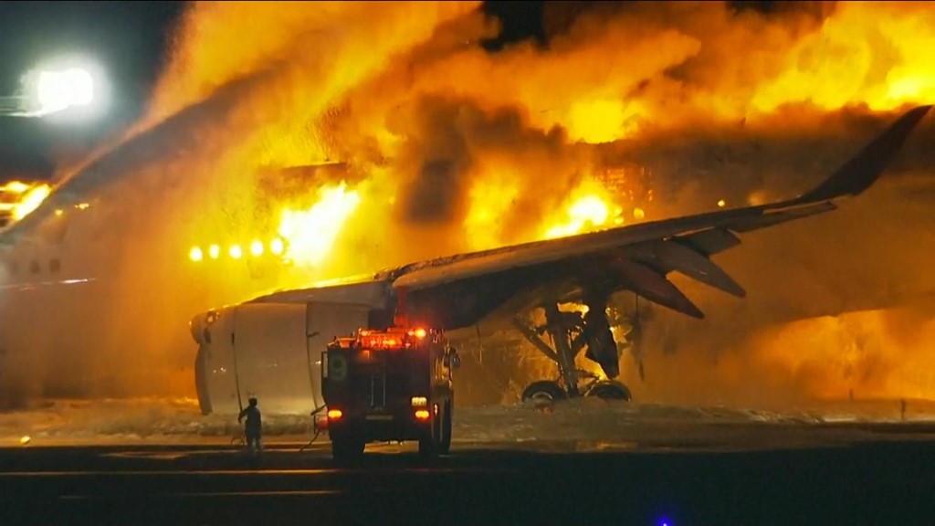 Japan plane fire latest: 'Hundreds' evacuated from plane; footage shows explosion as it taxies on runway | World News | Sky News