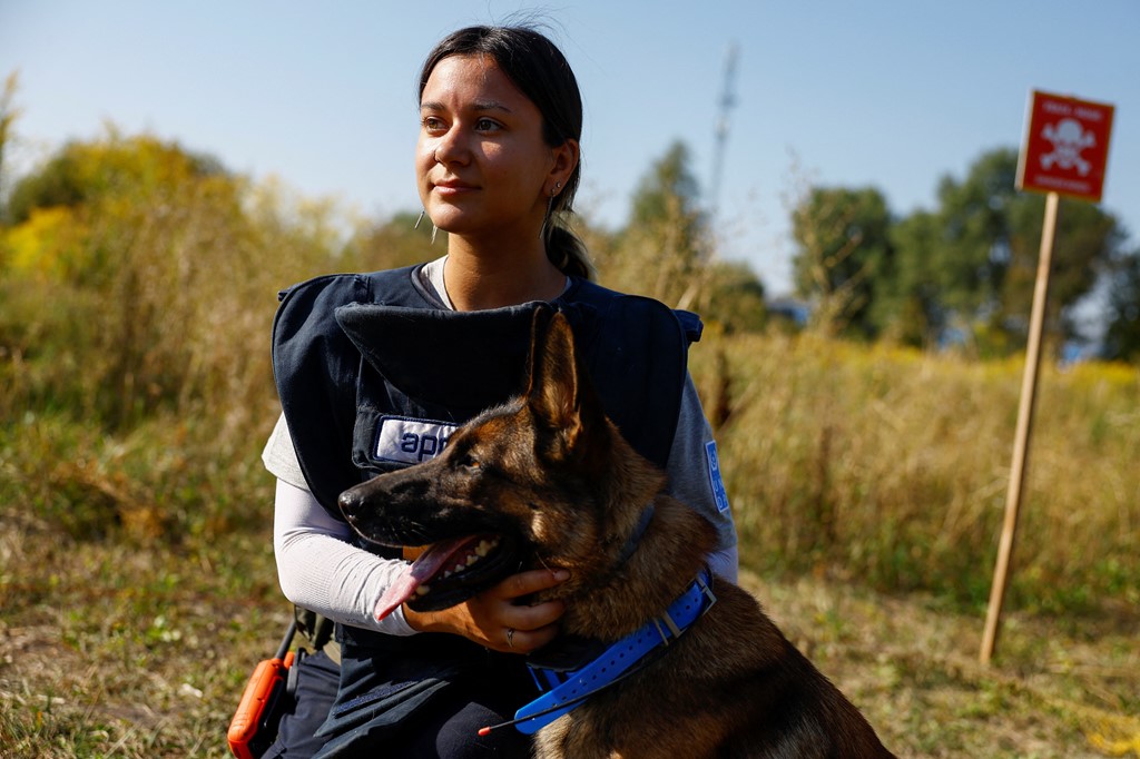 Karina hugs her Belgian shepherd service dog Tina