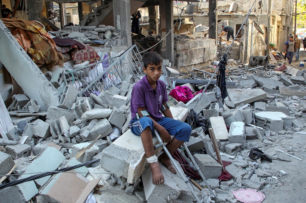 A wounded boy in the debris left after an Israeli strike