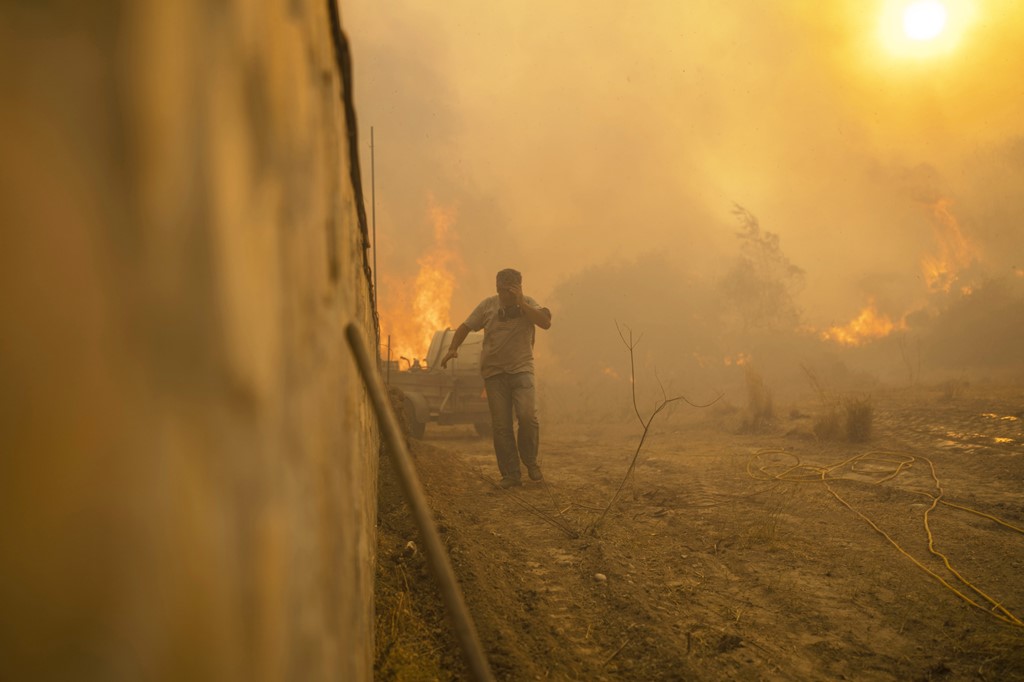 Elsewhere on Rhodes, locals desperately fight the flames themselves